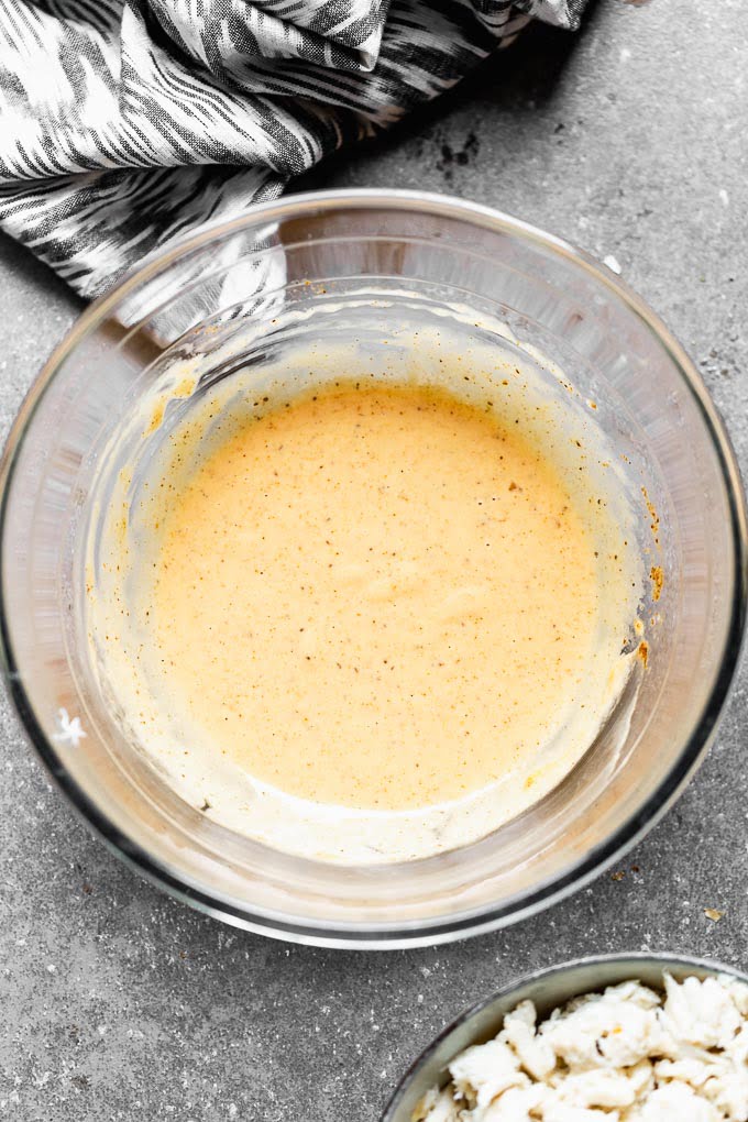 Whisk mayo, dijon, lemon juice, spices, egg, and hot sauce to a a large bowl. 