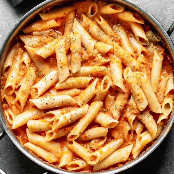 This Creamy Tomato Pasta Recipe is something we make at least a few times a month because it's easy to throw together and the whole family loves it! Bonus? It's packed with pureed carrots and Greek yogurt instead of cream, so it's also secretly healthy. A win for everyone. 