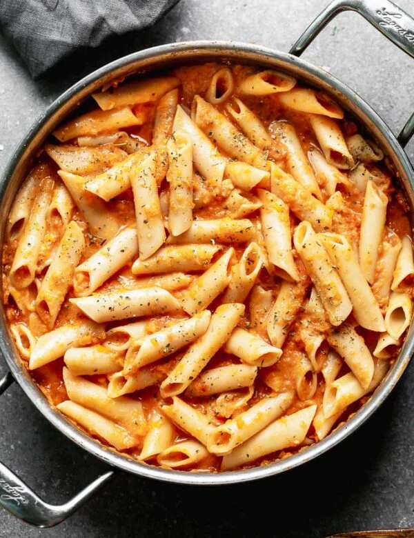 This Creamy Tomato Pasta Recipe is something we make at least a few times a month because it's easy to throw together and the whole family loves it! Bonus? It's packed with pureed carrots and Greek yogurt instead of cream, so it's also secretly healthy. A win for everyone. 