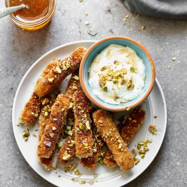 If you haven't had halloumi fries yet, you haven't lived! This Halloumi Fries Recipe with Honey Greek Yogurt is the perfect combination of sweet and salty, and such a great party food! We're in love.