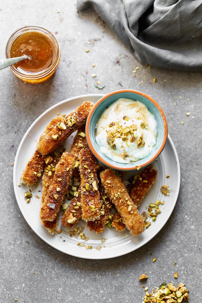 If you haven't had halloumi fries yet, you haven't lived! This Halloumi Fries Recipe with Honey Greek Yogurt is the perfect combination of sweet and salty, and such a great party food! We're in love.&nbsp;