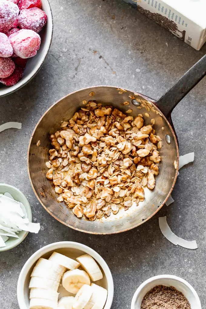 Walnut crumble with chopped walnuts, oats, honey, and coconut oil
