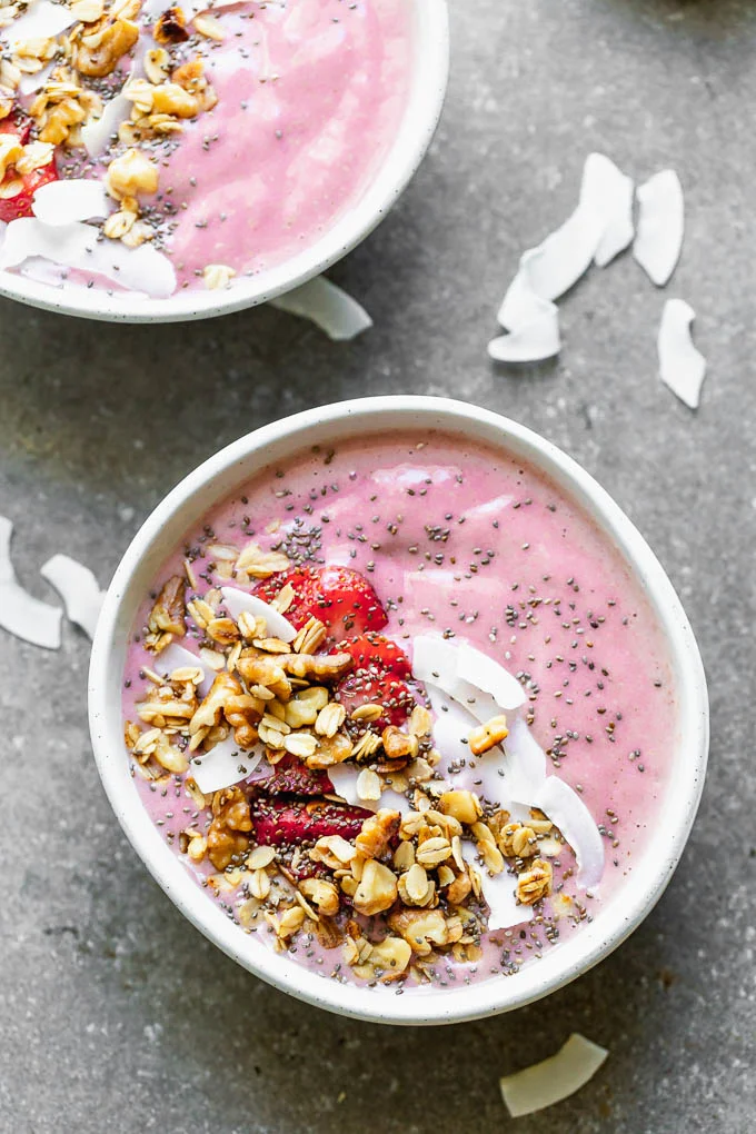 Strawberry Smoothie Bowls with Walnut Crumble – a healthy, filling, and delicious way to start your day. These are easy to throw together on busy mornings, and most importantly, fun for kids and parents to eat. They're packed with frozen strawberries, bananas, flax, and walnut milk and then topped with any easy oat and walnut mixture.