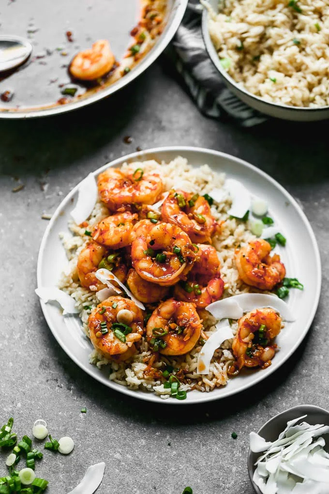 Caramel Shrimp with Coconut Rice: Sweet shrimp tossed in a salty brown sugar and soy sauce, studded with green onions, and served over coconut-infused rice to sop up all that delicious juice. Bonus? This is one of those 30-minute, no-fuss meals everyone in your family will love. 