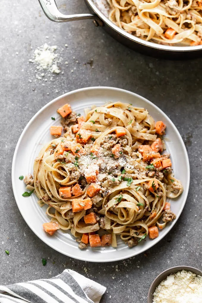 Creamy Sausage Pasta topped with parmesan cheese