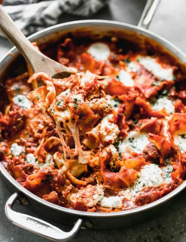 One Pot Deconstructed Lasagna is an easier, faster way to comforting lasagna! This is packed with an easy homemade red sauce, salty sausage, creamy ricotta cheese, and of course, plenty of gooey mozzarella cheese. It's the perfect way to enjoy lasagna any day of the week. 