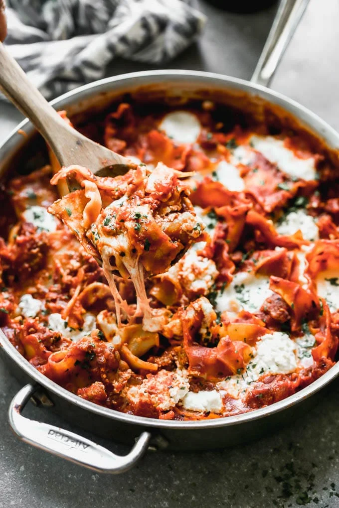 One Pot Deconstructed Lasagna is an easier, faster way to comforting lasagna! This is packed with an easy homemade red sauce, salty sausage, creamy ricotta cheese, and of course, plenty of gooey mozzarella cheese. It's the perfect way to enjoy lasagna any day of the week.&nbsp;