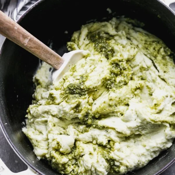 Pesto Mashed Potatoes are the perfect spin on typical Thanksgiving mashed potatoes. These ultra creamy mashed potatoes are silky-smooth and packed with the most delicious pesto flavor.