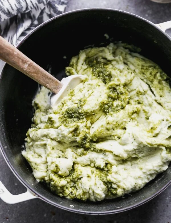 Pesto Mashed Potatoes are the perfect spin on typical Thanksgiving mashed potatoes. These ultra creamy mashed potatoes are silky-smooth and packed with the most delicious pesto flavor.