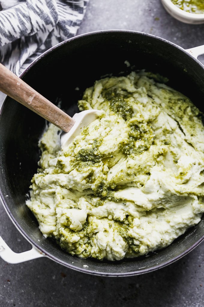Pesto Mashed Potatoes are the perfect spin on typical Thanksgiving mashed potatoes. These ultra creamy mashed potatoes are silky-smooth and packed with the most delicious pesto flavor.