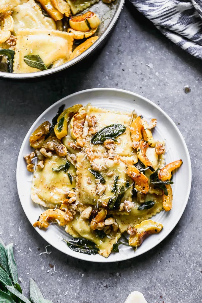 Ravioli with Brown Butter takes a simple store-bought ravioli and transforms it into a stunning dish perfect for a special occasion. This is packed with creamy sausage and ricotta-stuffed ravioli, an intoxicatingly nutty brown butter sauce, fried sage leaves, sweet roasted delicata squash, and crunchy walnuts. It's the perfect fall meal.&nbsp;