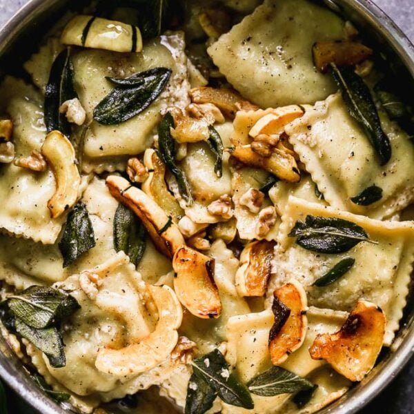 Ravioli with Brown Butter takes a simple store-bought ravioli and transforms it into a stunning dish perfect for a special occasion. This is packed with creamy sausage and ricotta-stuffed ravioli, an intoxicatingly nutty brown butter sauce, fried sage leaves, sweet roasted delicata squash, and crunchy walnuts. It's the perfect fall meal. 