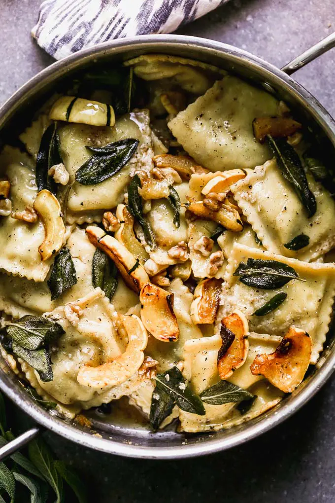 Ravioli with Brown Butter takes a simple store-bought ravioli and transforms it into a stunning dish perfect for a special occasion. This is packed with creamy sausage and ricotta-stuffed ravioli, an intoxicatingly nutty brown butter sauce, fried sage leaves, sweet roasted delicata squash, and crunchy walnuts. It's the perfect fall meal.&nbsp;