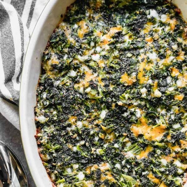 Cheesy Baked Spinach Casserole is for all you spinach lovers out there! This easy casserole is a dump-stir-and-bake dish that's packed with hearty spinach, sharp cheddar cheese, and a touch of nutmeg. It's the perfect healthy side dish for just about any meal. 