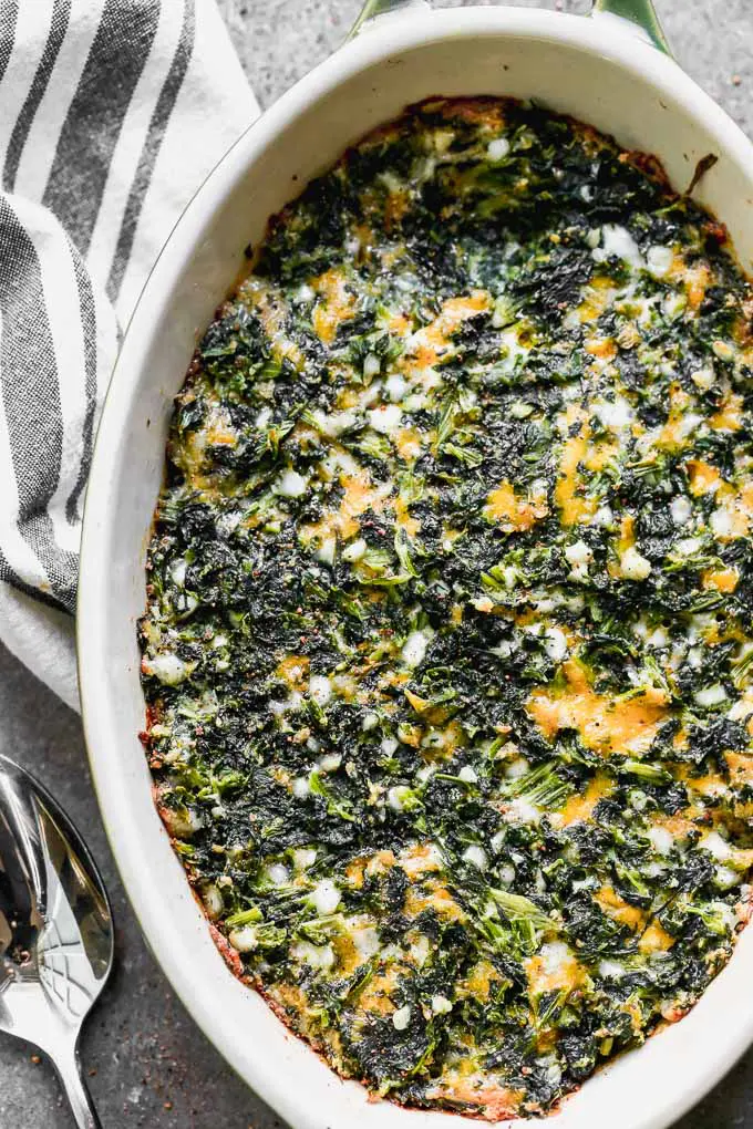 Cheesy Baked Spinach Casserole is for all you spinach lovers out there! This easy casserole is a dump-stir-and-bake dish that's packed with hearty spinach, sharp cheddar cheese, and a touch of nutmeg. It's the perfect healthy side dish for just about any meal. 