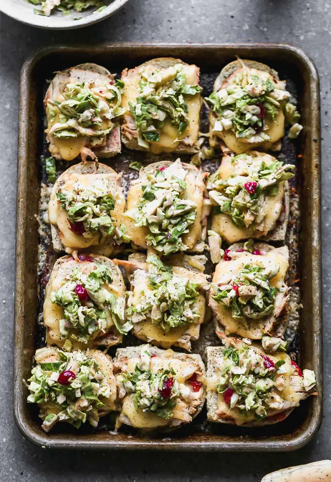The ultimate leftover Thanksgiving turkey melts! Slathered with cranberry mayo, topped with turkey, gooey smoked gouda, and a Brussels sprout slaw.