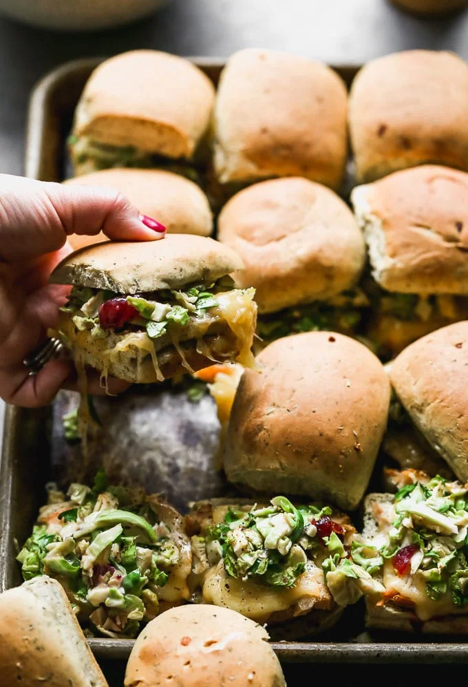The ultimate leftover Thanksgiving turkey melts! Slathered with cranberry mayo, topped with turkey, gooey smoked gouda, and a Brussels sprout slaw.