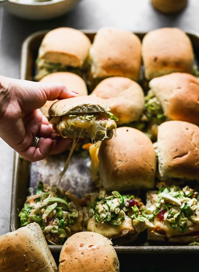 Cheesy leftover turkey melts with Brussels sprout slaw and cranberry mayo.
