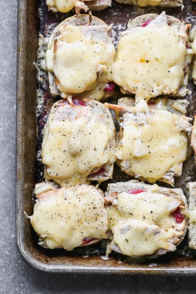 The ultimate leftover Thanksgiving turkey melts! Slathered with cranberry mayo, topped with turkey, gooey smoked gouda, and a Brussels sprout slaw.