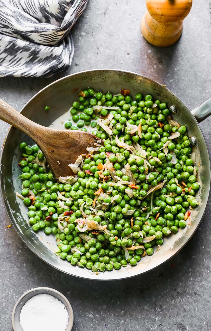 Creamy Peas and Pancetta look simple, but I assure you, there's ample flavor intertwined between those crisp, sweet peas and crispy pancetta. The peas are coated in a sweet and salty sherry-infused cream sauce and lots of caramelized shallots. They're the perfect way to make an easy side dish just a little bit more elevated than your average batch of buttered peas.&nbsp;