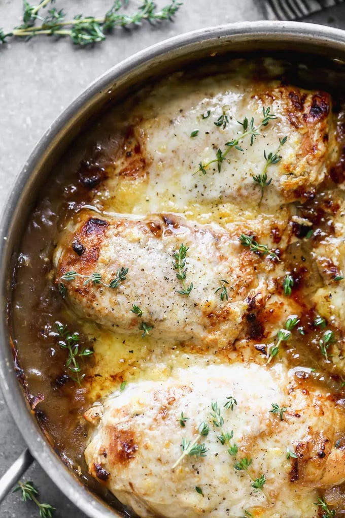 French Onion Chicken Skillet is French onion soup in a cheesy chicken skillet form! Tender chicken breasts are swimming in a thickened french onion sauce, covered with nutty grueyre cheese, and broiled until the cheese is gooey, golden brown, and crusty.
