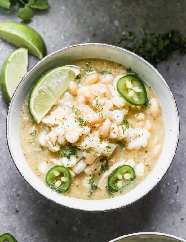 This Chicken Verde Soup is one of those soups that warms you from the inside out. It's slightly spicy from a jar of store-bought salsa verde and packed with onion, garlic, hints of cumin, and oregano. Heartiness comes in the form of shredded chicken, starchy hominy, and white beans. Bonus? It comes together in 30 minutes!