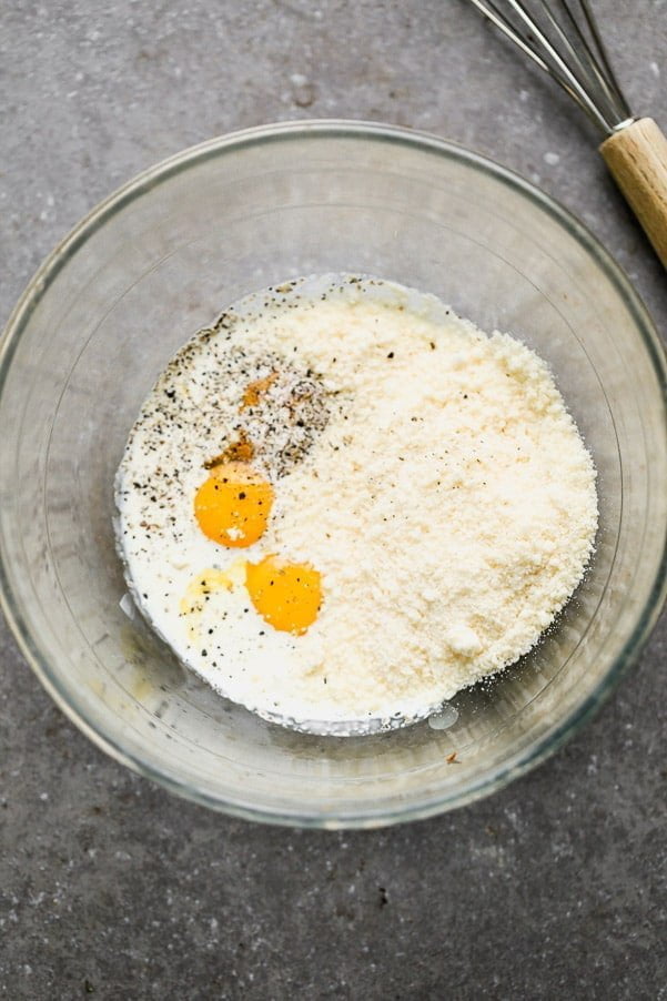 Whisk parmesan cheese, egg yolks, cream, and pasta water together. 