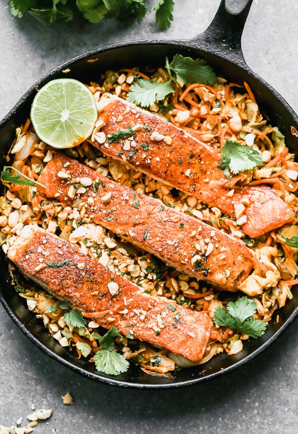 Pad Thai Salmon has all of the flavors of a classic pad Thai, but skips the noodles in lieu of sautéed veggies nestled beneath a crispy filet of salmon. Quick, easy, and healthy! &nbsp;