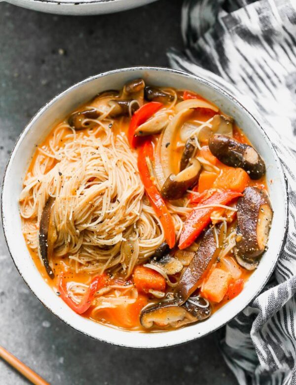 Vegetable Coconut Curry Soup with Rice Noodles is sweet, slightly spicy, and a cinch to throw together. It's packed with tender mushrooms, red bell peppers, onion, and the most delicious coconut curry broth you'll want to drink. It's served with plenty of thin brown rice noodles to slurp! 