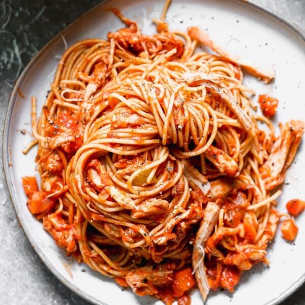 This healthy Chicken Bolognese uses chicken thighs that are slow-cooked in a red wine and a vegatable tomato sauce and tossed with whole-wheat spaghetti.