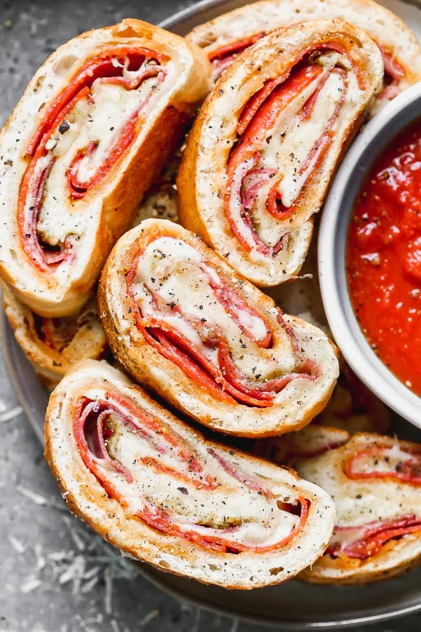 Italian Stromboli is only five ingredients and packed with spicy pepperoni, capicola and gooey mozzarella cheese, plus a simple pizza seasoning. So easy!