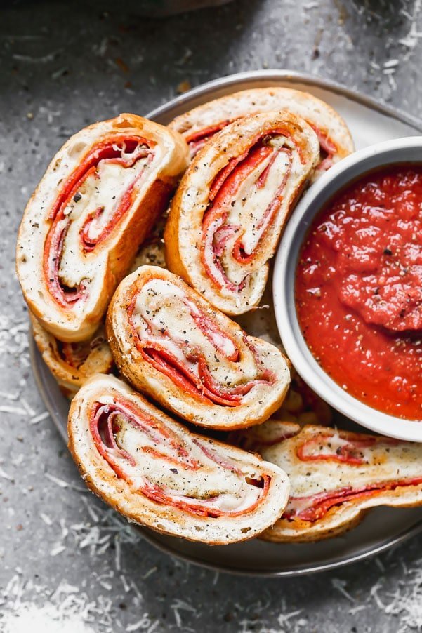 Italian Stromboli is only five ingredients and packed with spicy pepperoni, capicola and gooey mozzarella cheese, plus a simple pizza seasoning. So easy!