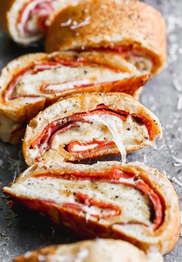 Italian Stromboli is only five ingredients and packed with spicy pepperoni, capicola and gooey mozzarella cheese, plus a simple pizza seasoning. So easy!