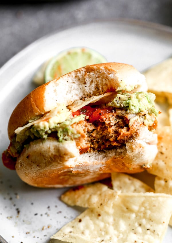 These Spicy Mexican Burgers are packed with all the best classic taco components. Spicy, smoky chicken patties, covered in gooey pepper jack cheese and smothered with smashed avocado, hot salsa, and crunchy tortilla chips.