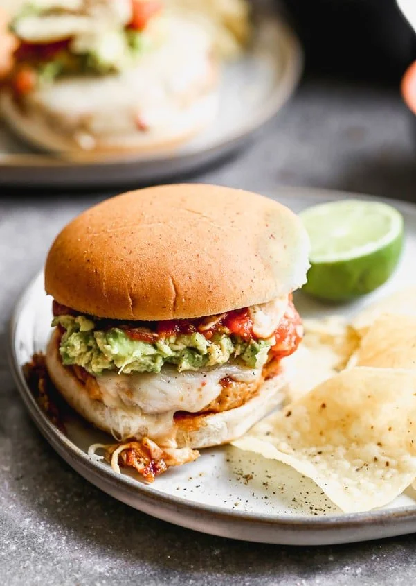 These Spicy Mexican Burgers are packed with all the best classic taco components. Spicy, smoky chicken patties, covered in gooey pepper jack cheese and smothered with smashed avocado, hot salsa, and crunch tortilla chips.