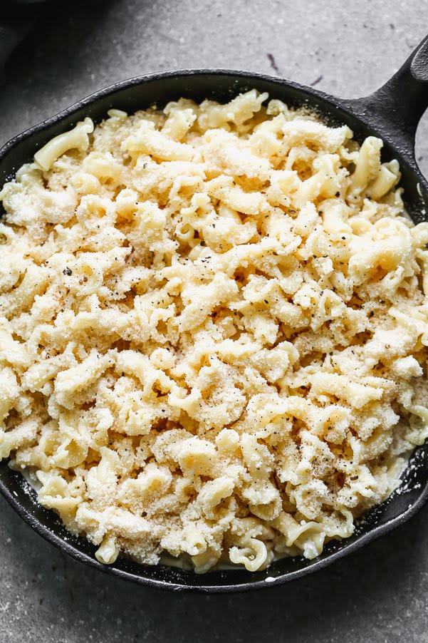 Cover pasta, cream, and cheese with grated parmesan 
