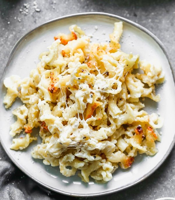 Cheesy Pasta Gratin is packed with aldente campanelle pasta, nutty parmesan cheese, sharp white cheddar, and just enough creamy to make the most luxurious, cheesy, thick sauce. It's so simple (only five ingredients!), and comes together very quickly.&nbsp;
