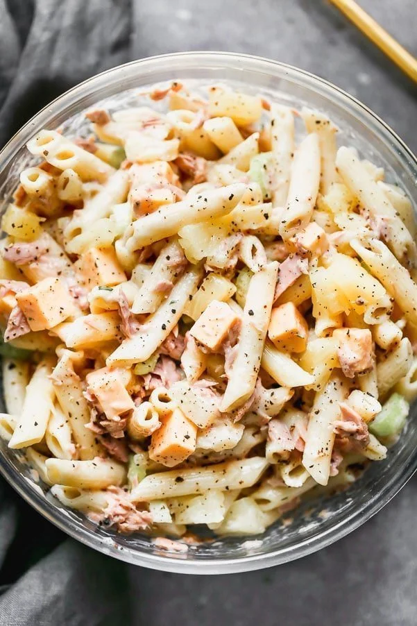 This Creamy Tuna Pasta Salad with Pineapple is one of my favorite lunches to make when I need to throw something together quickly from the pantry. Aldente penne noodles are tossed with flaked tuna, pineapple, crunchy celery, and creamy American cheese. Everything is then tossed in a super light mayo-based dressing that won't weigh you down.