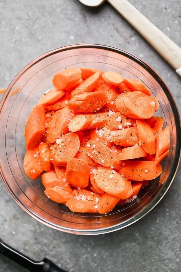 Raw sliced carrots with olive oil, salt, and pepper. 
