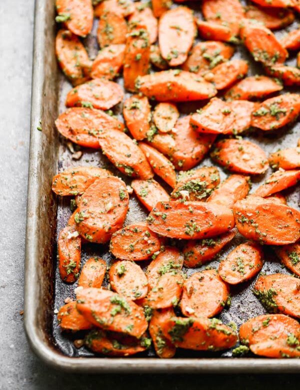 These Easy Roasted Carrots with Pecan Pesto are the perfect side dish for all your spring meals. Fresh spring carrots are roasted until soft and sweet and then tossed in a super easy pecan and spinach pesto. This recipe yields a large amount, so you’ll have plenty of leftovers to pull out during the week.