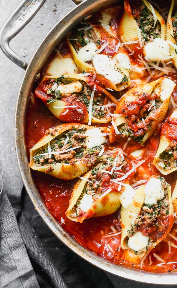 These Stuffed Pasta Shells with Ground Beef and Spinach are truly, the best stuffed shell recipe you'll find. They're packed with ground beef, nutty parmesan cheese, a little bit of spinach, and just enough creamy ricotta to hold the filling together. They're served in an easy marinara sauce, covered with fresh mozzarella and baked. Classic comfort food!&nbsp;