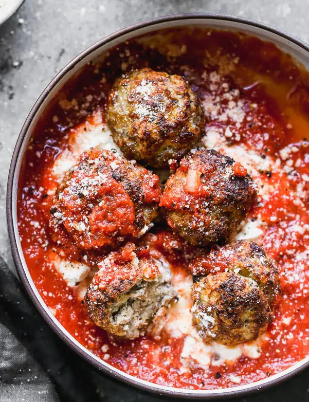 These Tender Ricotta Meatballs are light as air and packed with Italian sausage, parmesan cheese, garlic, and creamy ricotta cheese. They also happen to be baked Italian meatballs, so there's no mess! Perfect as an appetizer, or when paired with a salad, dinner. Easy and SO delicious.