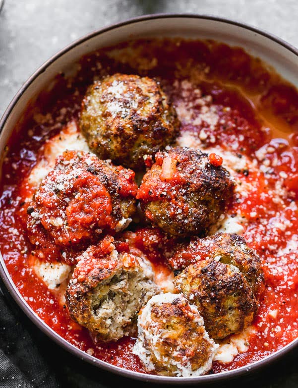 Tender Ricotta Meatballs: Baked and served with your favorite marinara and cream ricotta cheese! 