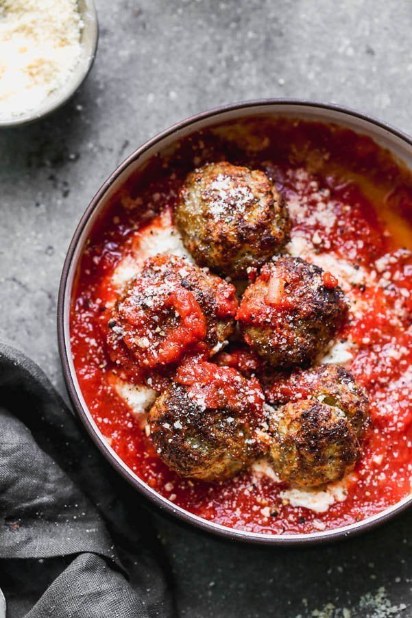 These Tender Ricotta Meatballs are light as air and packed with Italian sausage, parmesan cheese, garlic, and creamy ricotta cheese. They also happen to be baked&nbsp;Italian meatballs, so there's no mess! Perfect as an appetizer, or when paired with a salad, dinner. Easy and SO delicious.