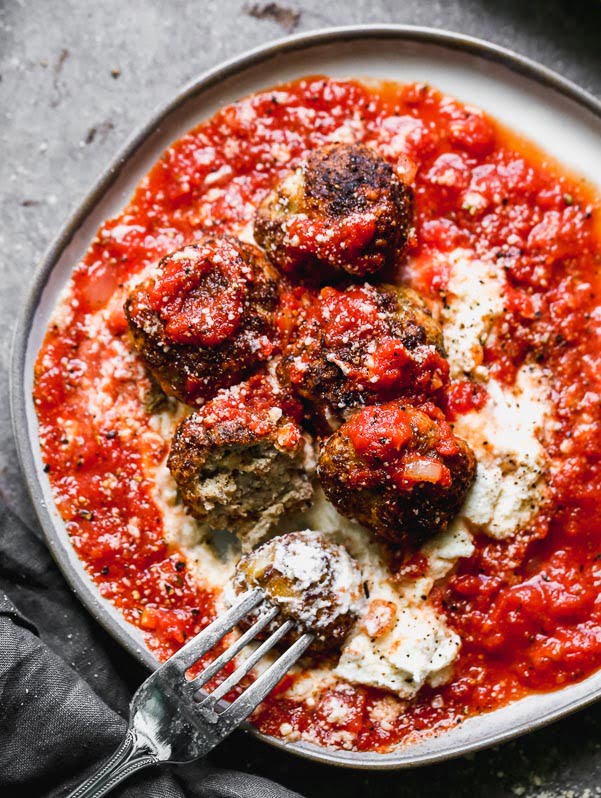 These Tender Ricotta Meatballs are light as air and packed with Italian sausage, parmesan cheese, garlic, and creamy ricotta cheese. They also happen to be baked Italian meatballs, so there's no mess! Perfect as an appetizer, or when paired with a salad, dinner. Easy and SO delicious.