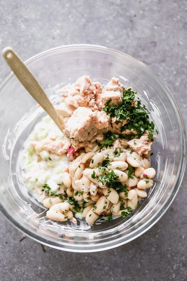Mix tuna, white beans, onion, mayo, vinegar, and lemon juice. 