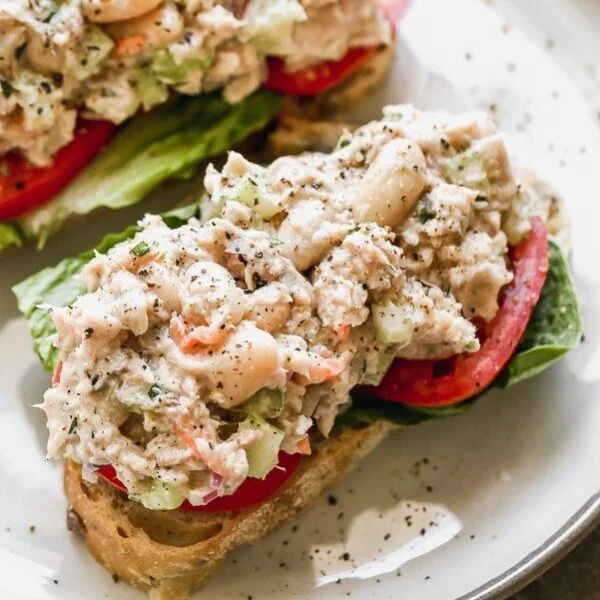 This is the Tuna White Bean Salad of my dreams. Easy to make, and packed with flaky tuna, creamy white beans, crunchy celery and red onion, and tossed a light dressing made with just enough low-fat mayo, lemon juice,  and acidic white wine vinegar. Pair with hearty whole-grain bread and serve with crisp romaine lettuce and sliced tomatoes. 