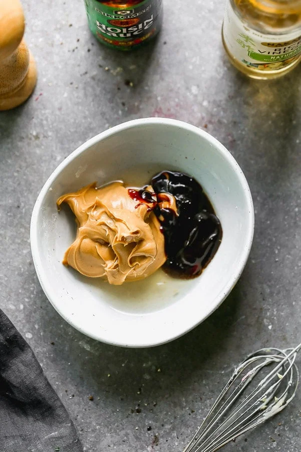 Mix peanut butter, hoisin, rice vinegar, water, and salt together in a bowl. 