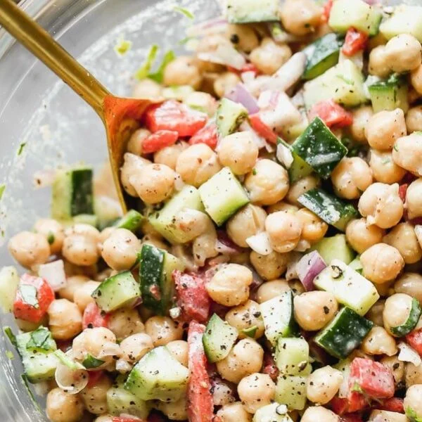 Cucumber and Chickpea Salad is refreshing, healthy, and packed with flavor and texture. It's simple. Hearty protein-packed chickpeas are tossed with crunchy cucumber, smoky roasted red peppers, and red onions. It's all tossed in a creamy red wine vinegar and tahini dressing with just a hint of smokiness from ground sumac. The perfect lunch or side for dinner. 