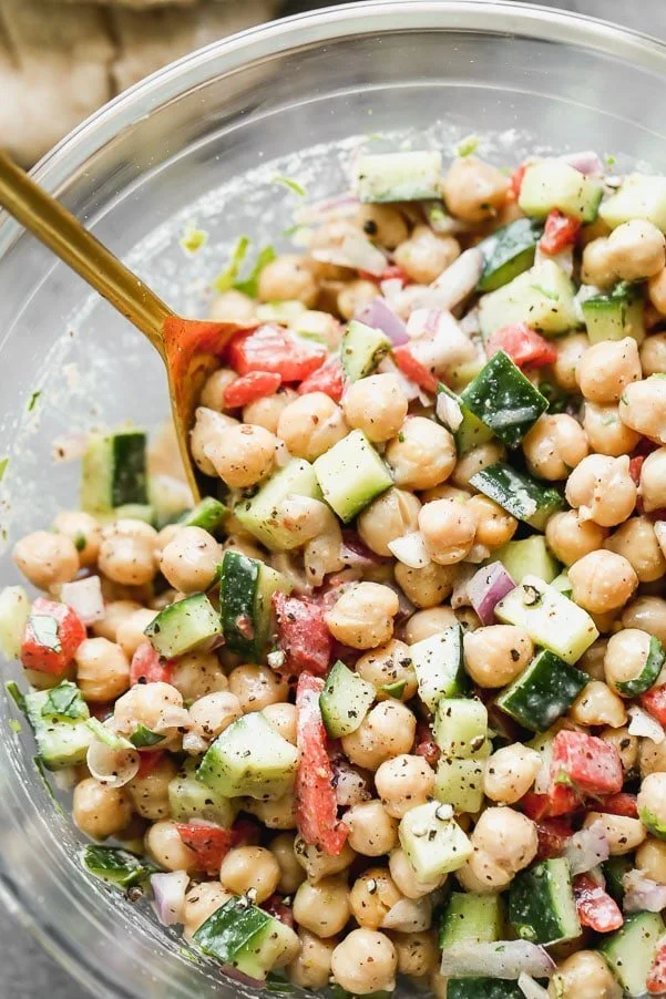 Cucumber and Chickpea Salad is refreshing, healthy, and packed with flavor and texture. It's simple. Hearty protein-packed chickpeas are tossed with crunchy cucumber, smoky roasted red peppers, and red onions. It's all tossed in a creamy red wine vinegar and tahini dressing with just a hint of smokiness from ground sumac. The perfect lunch or side for dinner.&nbsp;